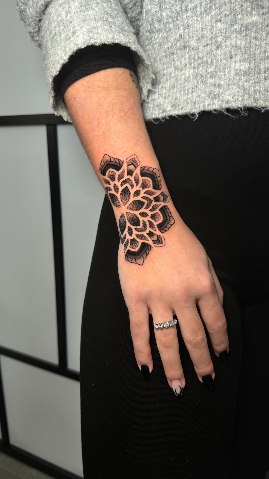 Wrist mandala — dense dotwork on the wrist